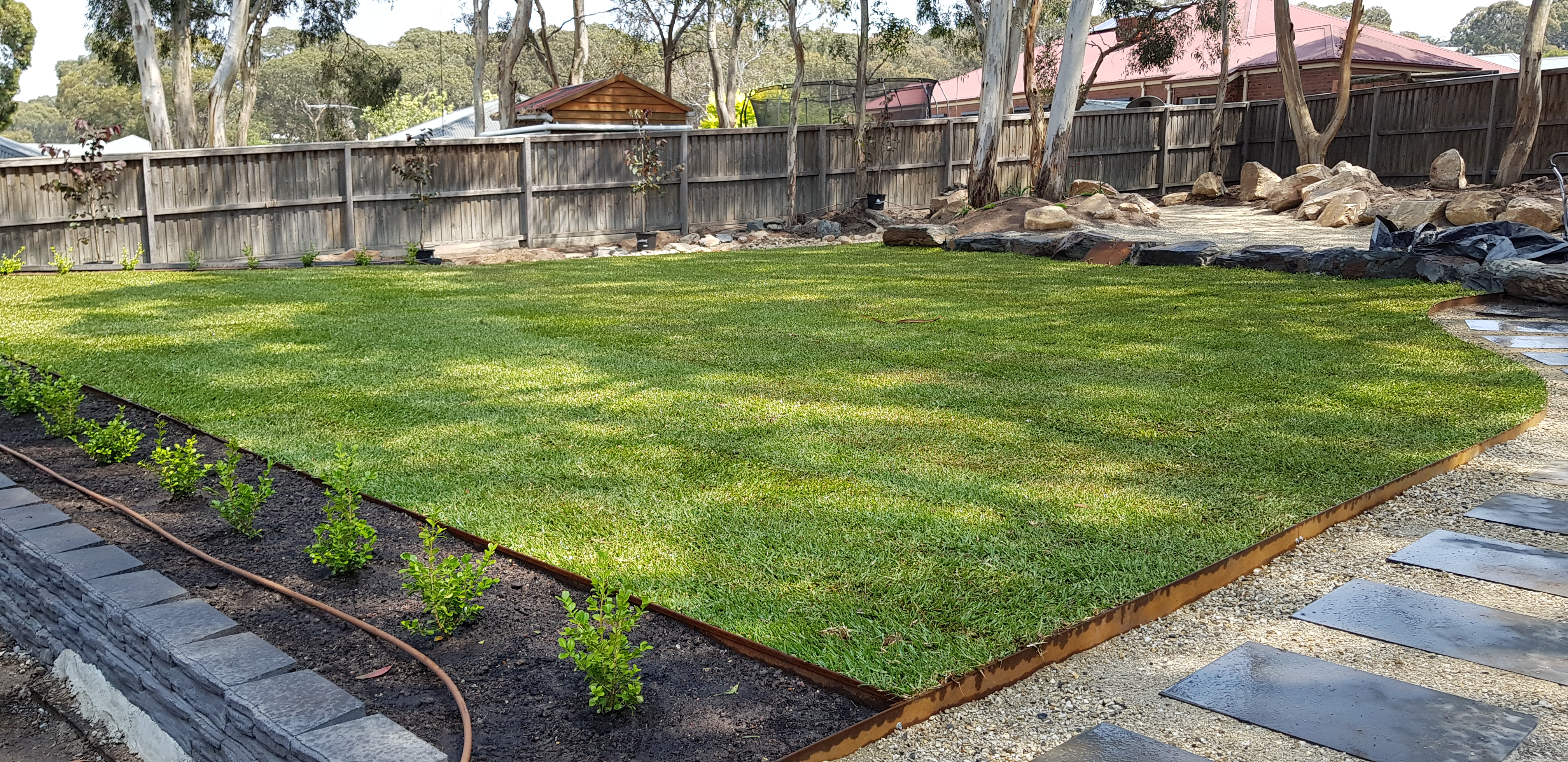 After — fresh instant turf with irrigation, edging and garden beds